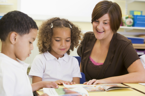 Teacher reading to two children