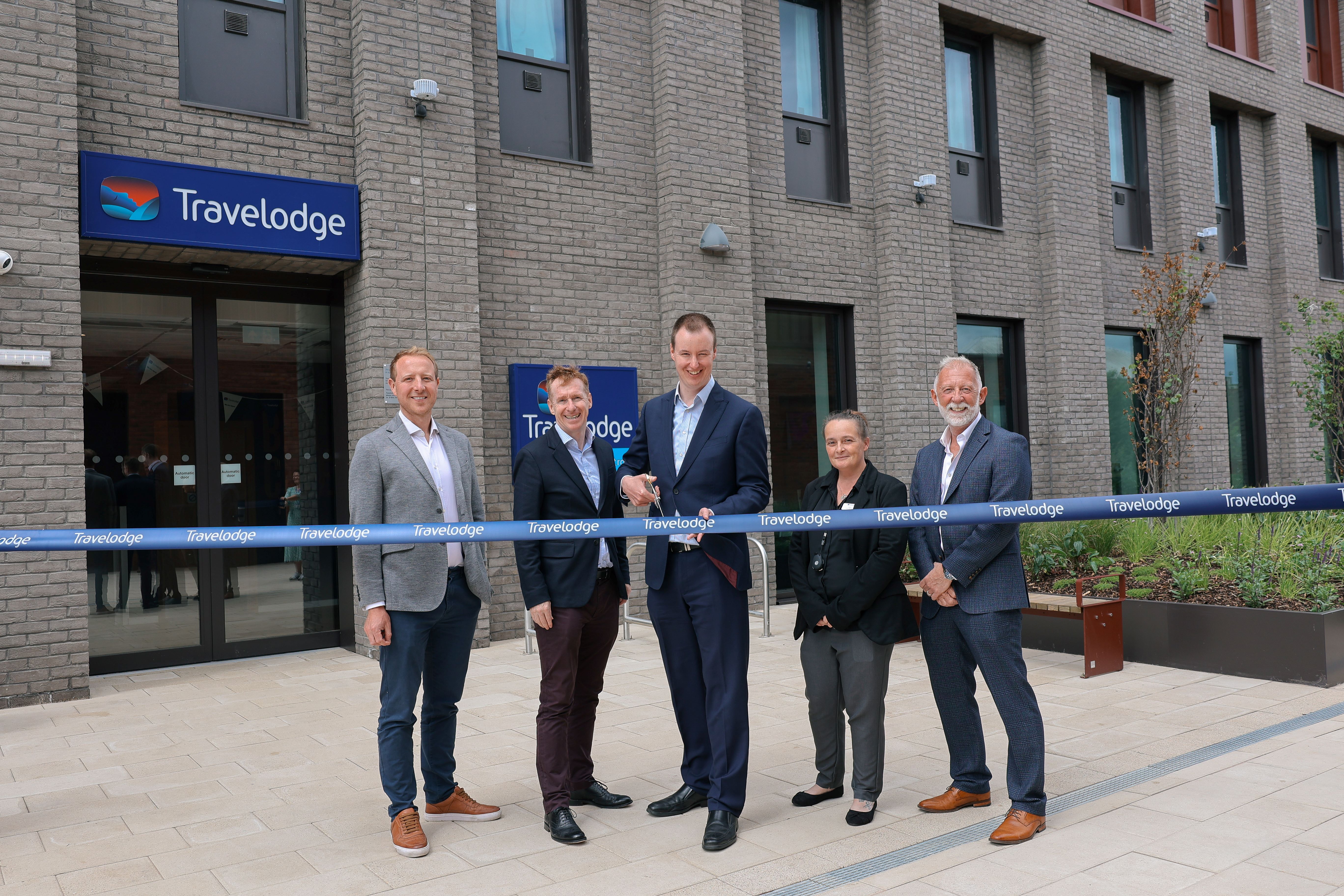 Council 
Leader, Cllr Chris Read, with the new Travelodge behind him in a special ribbon cutting 
ceremony
