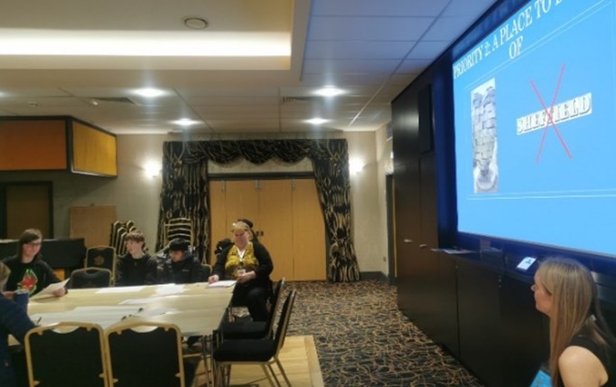 Young inspectors sat at a table with a presentation on display